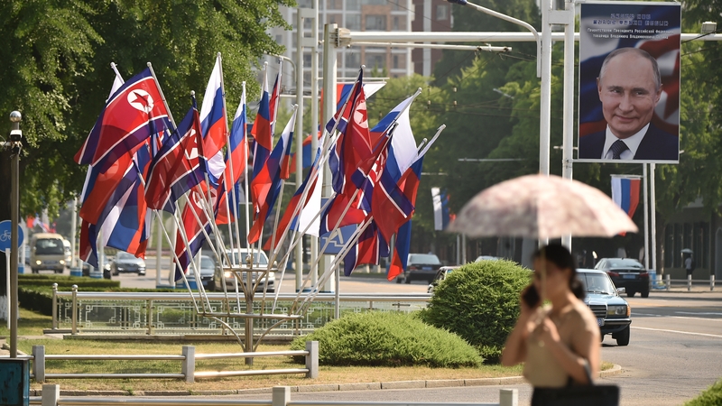A portrait of Russian President Vladimir Putin is seen near national flags of North Korea and Russia in Pyongyang last year
