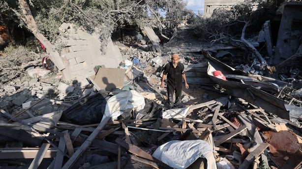 A man checks the damage in the aftermath of an overnight Israeli strike that hit Nuseirat in central Gaza on July 13