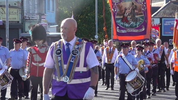 Orange Order parade passes through the interface Ardoyne shops area of north Belfast