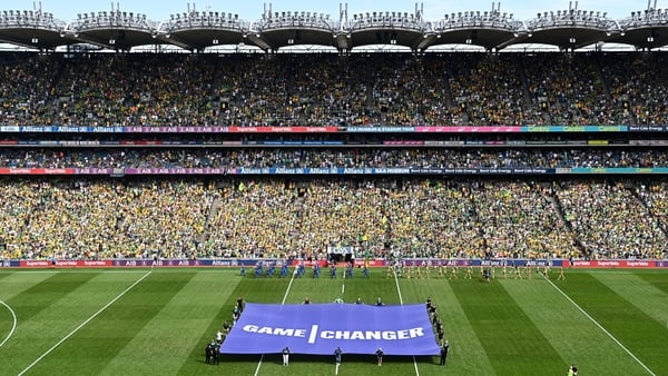 Croke Park stadium with a crowd of people with a purple banner saying 'game changer'