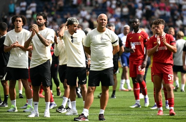 Liverpool's Dutch manager Arne Slot reacts as players applaud the fans following the pre-season friendly football match between Preston North End and Liverpool at Deepdale stadium in Preston, north-west England on July 13, 2025. Liverpool are to retire Diogo Jota's number 20 shirt in honour of the P