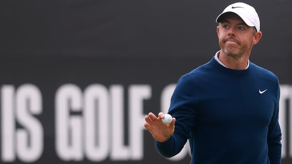 NORTH BERWICK, SCOTLAND - JULY 13: Rory McIlroy of Northern Ireland raises his ball as he acknowledges the crowd after putting on the 18th green on day four of the Genesis Scottish Open 2025 at The Renaissance Club on July 13, 2025 in North Berwick, Scotl