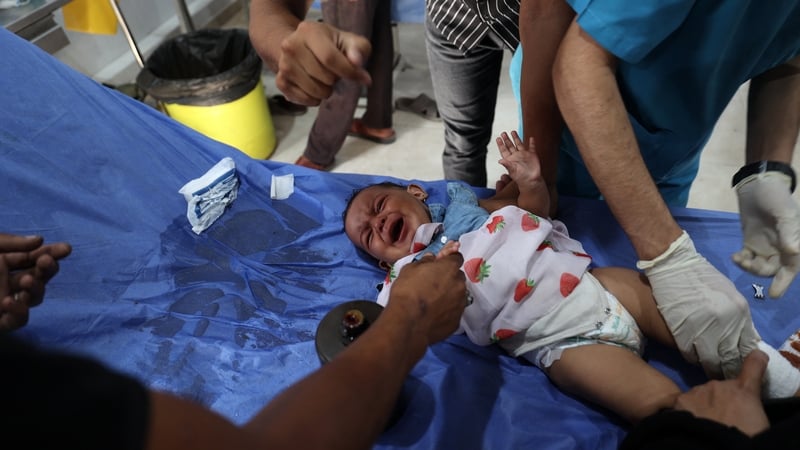 Medics treat an injured Palestinian baby at the Al-Awda hospital in central Gaza after an Israeli attack