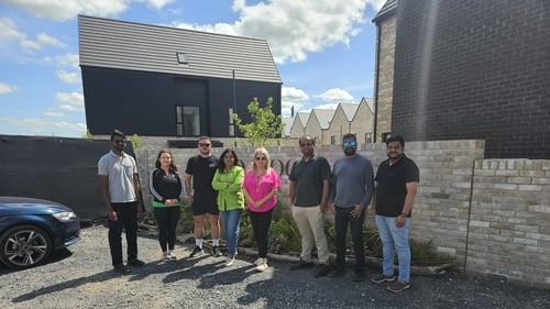 Some of the Sand Wood homeowners pictured outside their new houses which have yet to be connected to the ESB Networks grid