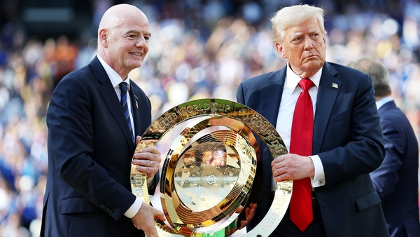 Gianni Infantino, President of FIFA, and U.S. President Donald Trump hold onto the FIFA Club World Cup trophy