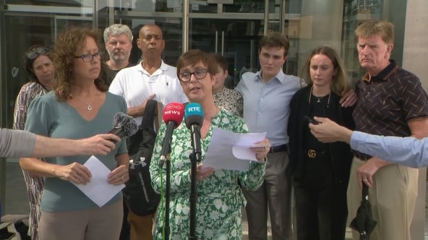 A woman reads a statement outside court