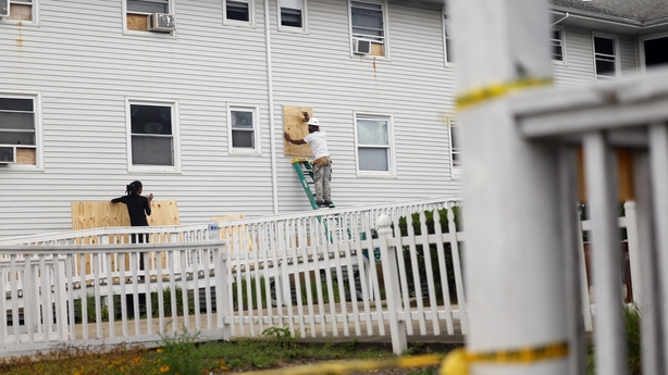 a couple of men on a ladder on a white railing
