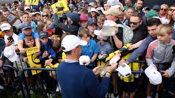 Rory McIlroy of Northern Ireland signs autographs for fans during a practice round prior to The 153rd Open Championship