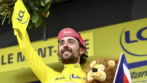 Irish Ben Healy of EF Education-EasyPost celebrates on the podium in the yellow jersey of leader in the overall ranking after stage 10 of the 2025 Tour de France cycling, from Ennezat to Le Mont-Dore Puy de Sancy (169 km), on Monday 14 July 2025 in France