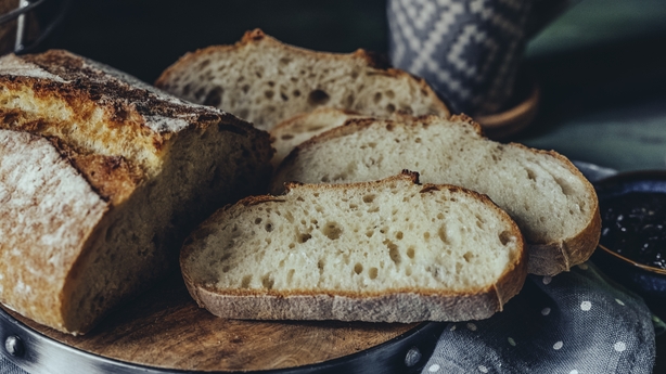 a sliced bread on a wooden plate