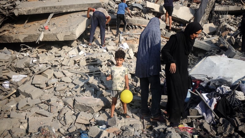 People search for their belongings amid the debris of destroyed houses in the aftermath of Israeli bombardment in Gaza City