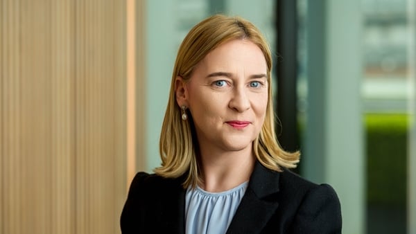 Picture of Ciara Ryan, AIB's Head of Wealth and Insurance, posing for a picture in a dark suit