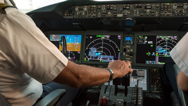 Stock image of the inside of a cockpit on a commercial airplane