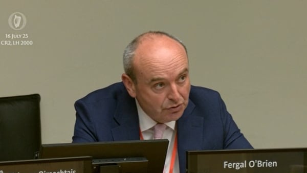 a person in a suit sitting at a table