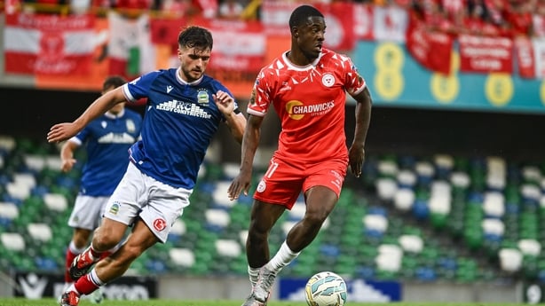 16 July 2025; Mipo Odubeko of Shelbourne in action against Euan East of Linfield during the UEFA Champions League First Qualifying Round second leg match between Linfield and Shelbourne at Clearer Twist National Football Stadium at Windsor Park in Belfast. Photo by Ben McShane/Sportsfile