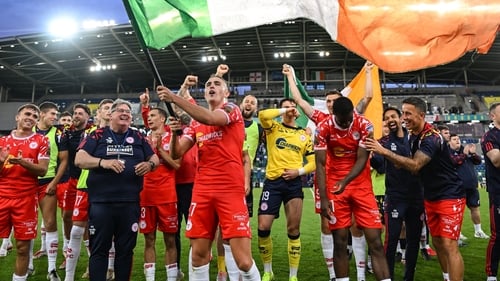 The Shelbourne players celebrate at full-time in Windsor Park