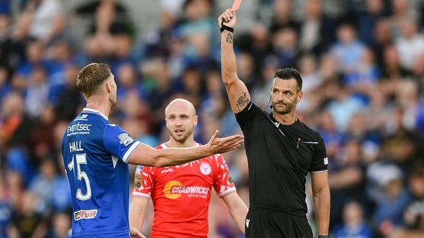 16 July 2025; Referee Andrew Madley shows a red card to Ben Hall of Linfield during the UEFA Champions League First Qualifying Round second leg match between Linfield and Shelbourne at Clearer Twist National Football Stadium at Windsor Park in Belfast. Photo by Stephen McCarthy/Sportsfile