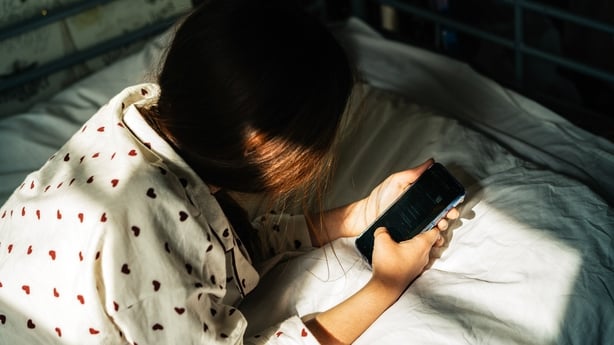 Stock image of a teenage girl using a smartphone