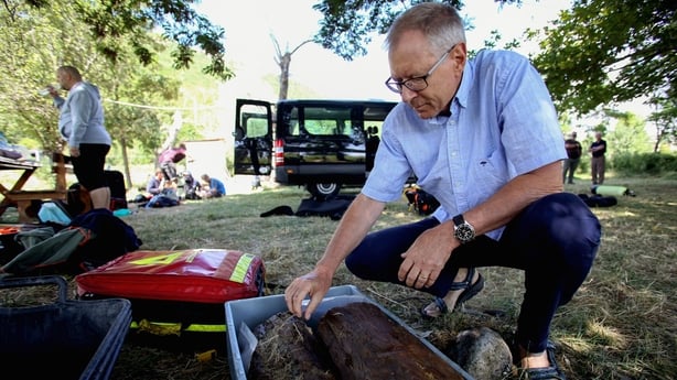 Swiss archaeologist Albert Hafner identifies objects discovered near the shoreline of the Lin Village in the waters of Lake Ohrid, southeastern Albania on July 27, 2023