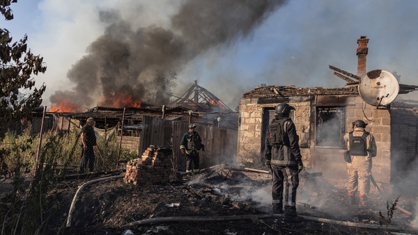 Ukrainian emergency service workers extinguish a fire in 3 houses after Russian shelling - (Photo by Diego Herrera Carcedo/Anadolu via Getty Images)