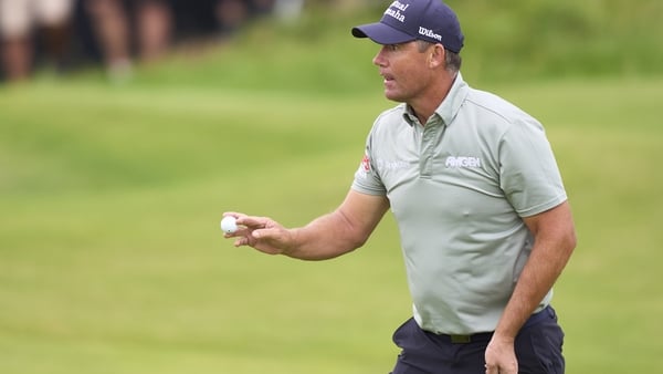Padraig Harrington holding a golf ball on the 13th green at the 2025 Open Championship.