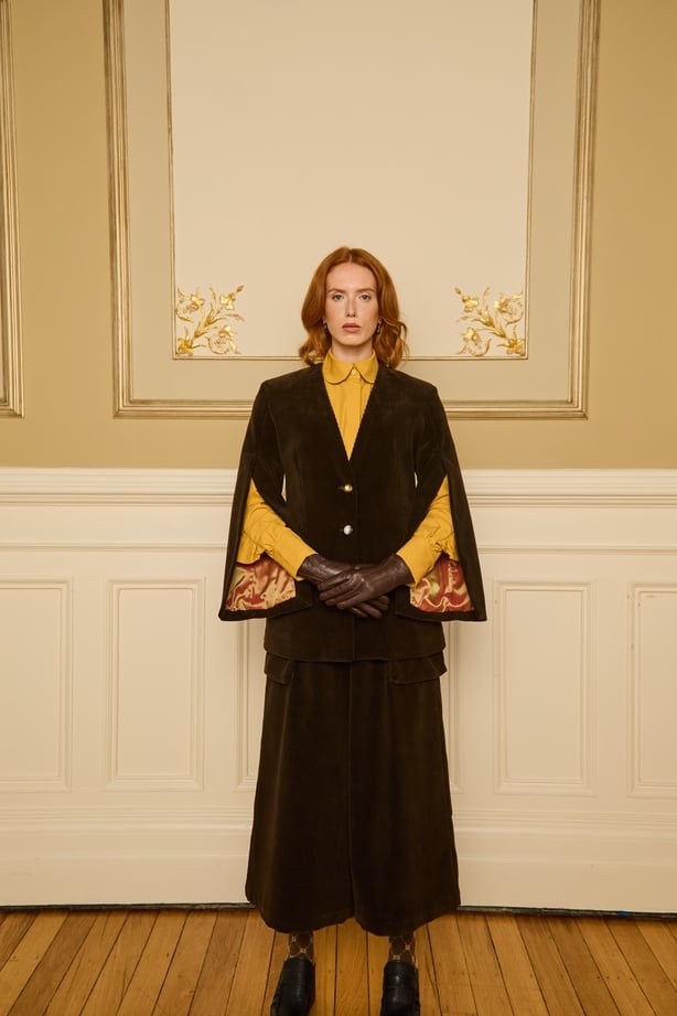 a person in a brown cape