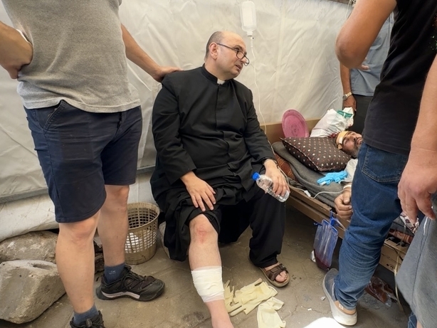 Wounded Palestinians, including Father Gabriel Romanelli, are brought to Al-Ahli Baptist Hospital after an Israeli attack targeted the Holy Family Church in eastern Gaza City