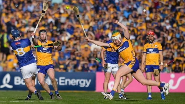 Alan Tynan of Tipperary gets a shot off despite the efforts of Clare players, from left, Tony Kelly and Sean Rynne during the Munster GAA Hurling Senior Championship Round 3 match between Clare and Tipperary at Zimmer Biomet Páirc Chíosóg in Ennis, Clare. 