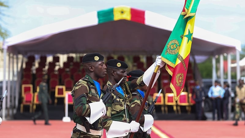Senegalese soldiers parade during a handover ceremony at Camp Geille