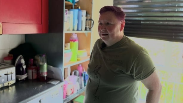 a person standing in a kitchen