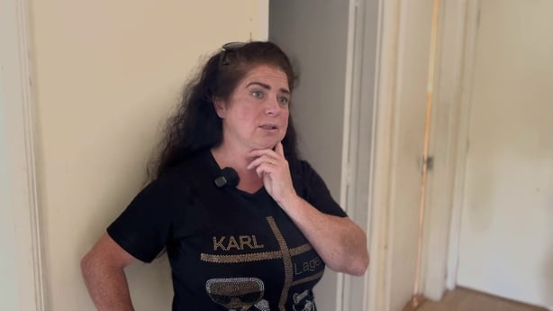 a person with her hand on her chin