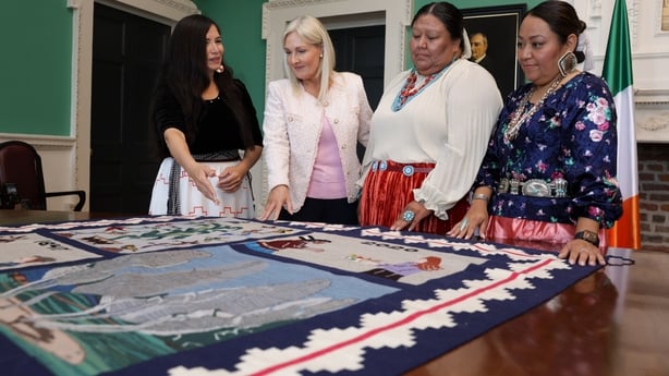 Ceann Comhairle Verona Murphy receives a handwoven rug gifted to the people of Ireland as a thank you from two Native American nations