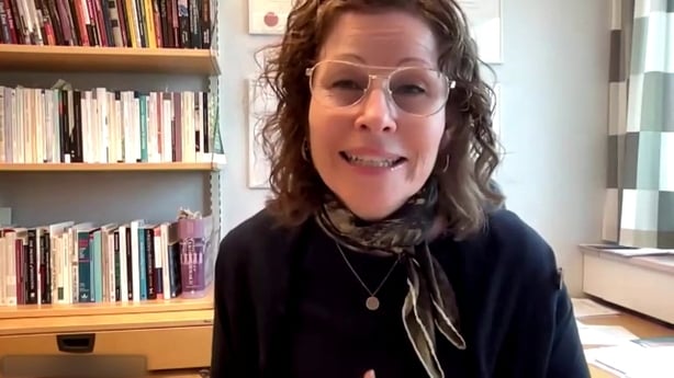 a person wearing glasses and a scarf