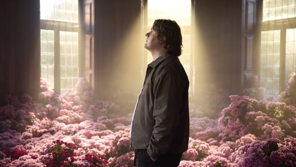 a person standing in a room with flowers