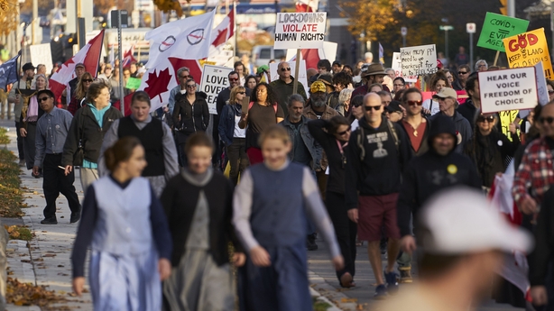 People protesting Covid restrictions, including mask wearing, march through the streets in Aylmer, Ontario, on November 7, 2020 