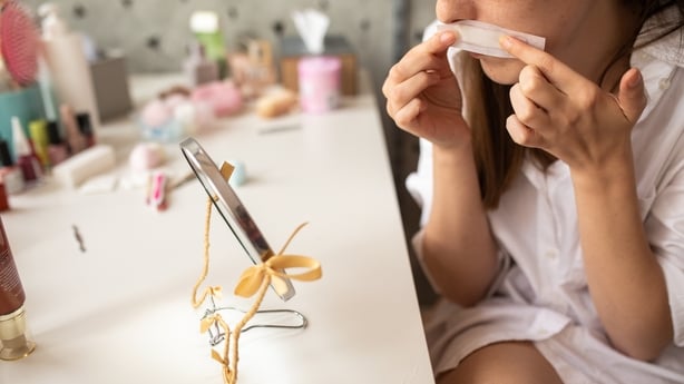 Woman preparing to get rid of unwanted hair on her upper lip at home