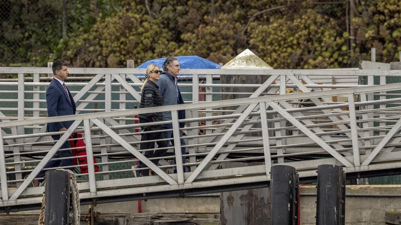 Pam Bondi and Doug Burgum are seen on a boat ramp after they arrived at Alcatraz Prison