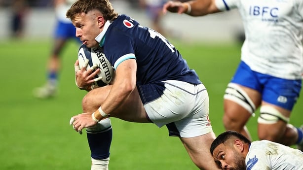 Scotland's Arron Reed (L) is tackled by Samoa's Duncan Paia'Aua