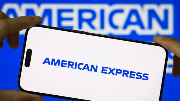 The American Express logo on a mobile phone against a blue background