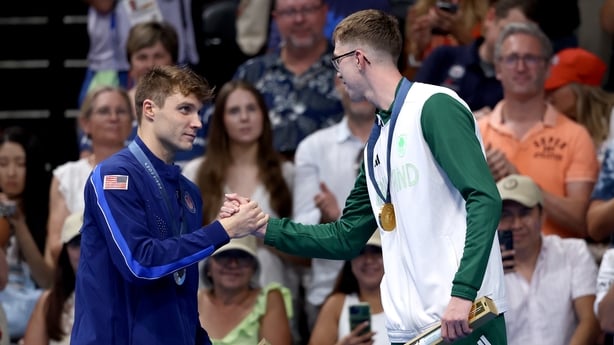 NANTERRE, FRANCE - JULY 30: Gold Medalist Daniel Wiffen of Team Ireland shakes hands with Silver Medalist Bobby Finke of Team United States on the podium during the Swimming medal ceremony after the Men's 800m Freestyle Final on day four of the Olympic Games Paris 2024 at Paris La Defense Arena on J
