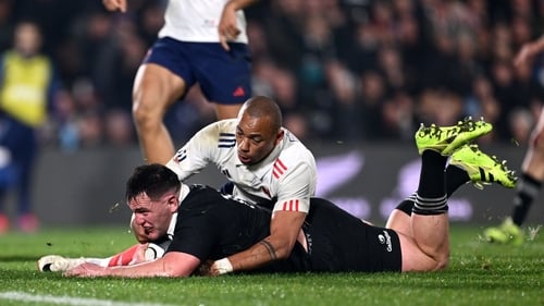 Brodie McAlister of New Zealand dives towards the try line to score his try