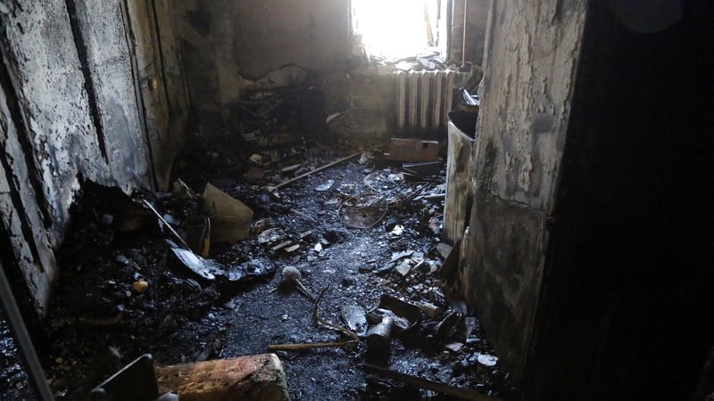 An interior view of a burned-out apartment in a residential building damaged by a Russian drone strike