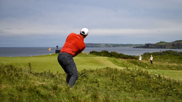 Rory McIlroy plays from the rough on five