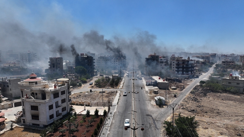 Smoke rising in the city of Sweida in southern Syria yesterday