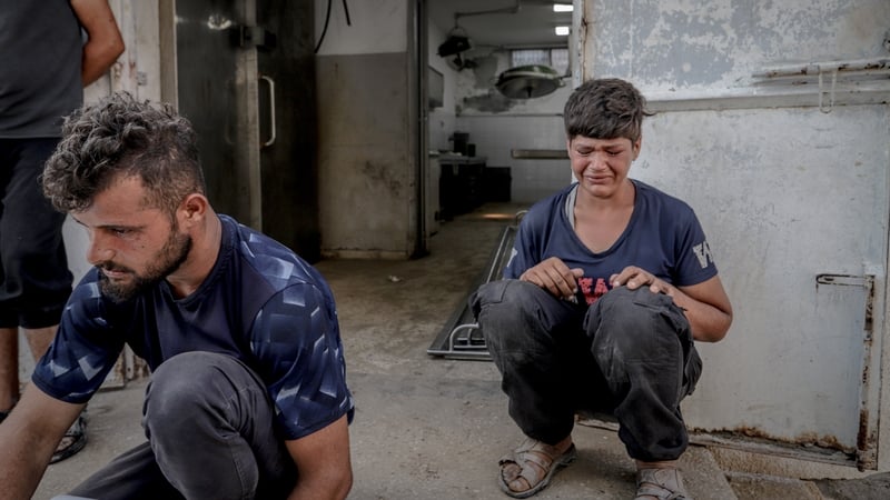 Palestinians mourn following the deaths of relatives in Israeli attacks in northern Gaza