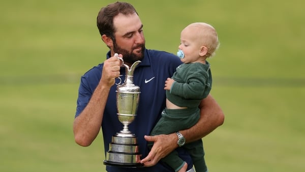 Scottie Scheffler of the United States celebrates with his son Bennett Scheffler and the Claret Jug on the 18th green after winning The 153rd Open Championship at Royal Portrush