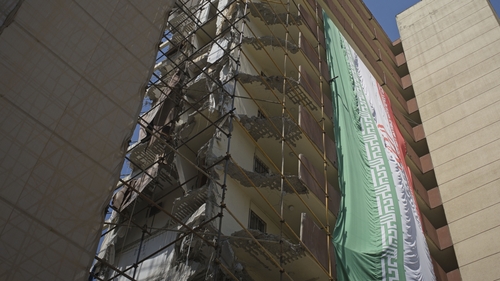 An Iranian flag hangs on a destroyed housing compound targeted during the Iran-Israel 12-day war in Tehran