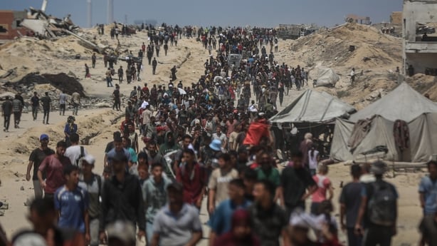Crowds of people carrying their belongings are seen leaving central Gaza after the Israeli military issued evacuation orders on 20 July 2025