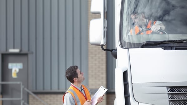 UK, Truck driver talking to driving instructor