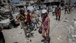 a child walking in a destroyed area